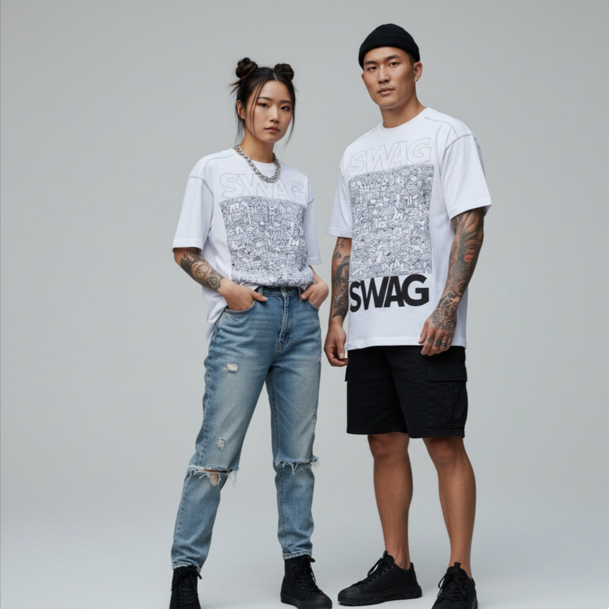Two people wearing matching t-shirts with a 'SWAG' print on a gray background